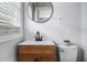 Modern bathroom features a sleek vanity with updated fixtures and a round mirror at 829 Burton St, Rocky Mount, NC 27803