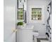 Bathroom featuring modern fixtures, a decorative mirror, and a patterned shower curtain at 829 Burton St, Rocky Mount, NC 27803