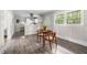 Dining area with wood table and chairs with kitchen featuring modern countertops and cabinets at 829 Burton St, Rocky Mount, NC 27803