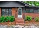A close-up of the front entrance with brick stairs and black iron railings at 829 Burton St, Rocky Mount, NC 27803