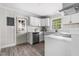 Modern kitchen featuring stainless steel appliances, quartz countertops, and vinyl plank flooring at 829 Burton St, Rocky Mount, NC 27803