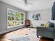 Bright living room with hardwood floors, ceiling fan and a large window with natural light at 829 Burton St, Rocky Mount, NC 27803