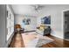 Cozy living room with gray sofa, natural light, hardwood floor and modern abstract art at 829 Burton St, Rocky Mount, NC 27803