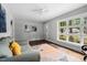 Inviting living room with hardwood floors, gray sofa, large window, and modern abstract art at 829 Burton St, Rocky Mount, NC 27803