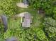 An aerial view of a home featuring a well-maintained lawn, mature trees and a backyard deck at 8509 Oneal Rd, Raleigh, NC 27613