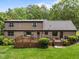 Two-story home with wooden deck and outdoor seating area surrounded by lush greenery at 8509 Oneal Rd, Raleigh, NC 27613