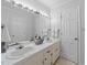 Bathroom with double sinks, white cabinets, a large mirror and plenty of counter space at 8509 Oneal Rd, Raleigh, NC 27613