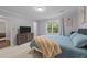 Bedroom with large window, neutral carpet, and modern furniture at 8509 Oneal Rd, Raleigh, NC 27613
