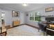 This is a cozy bedroom with wood floors, a large window, and neutral-colored walls at 8509 Oneal Rd, Raleigh, NC 27613
