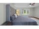Relaxing main bedroom suite features a plush bed, ceiling fan, and a large window with shutters at 8509 Oneal Rd, Raleigh, NC 27613