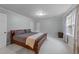 Spacious bedroom featuring carpet floors, gray walls, natural lighting, and a wooden bed at 8509 Oneal Rd, Raleigh, NC 27613