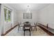 Bright dining area with a glass table, modern chandelier, and stylish decor at 8509 Oneal Rd, Raleigh, NC 27613