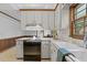 Traditional kitchen with white cabinets, wood trim, granite countertops, and stainless steel stove at 8509 Oneal Rd, Raleigh, NC 27613