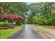 Tree-lined street view with sidewalks and landscaping, enhancing neighborhood charm at 8509 Oneal Rd, Raleigh, NC 27613