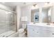 Bright bathroom featuring double sinks, a glass shower, and elegant finishes at 8615 Kenridge Ln, Fuquay Varina, NC 27526