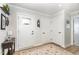 Welcoming foyer with a decorative front door, tiled floor, and coat closet for storing outerwear at 8615 Kenridge Ln, Fuquay Varina, NC 27526
