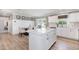 Well-lit kitchen with island, stainless appliances, and a dining area with backyard views at 8615 Kenridge Ln, Fuquay Varina, NC 27526