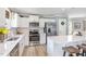 Bright kitchen with stainless steel appliances, white cabinets, and a kitchen island with barstool seating at 8615 Kenridge Ln, Fuquay Varina, NC 27526
