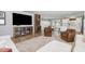 Open concept living room with modern furniture, a large TV, and a view into the kitchen and dining areas at 8615 Kenridge Ln, Fuquay Varina, NC 27526
