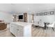 Open-concept living area featuring a kitchen island, dining area, and comfortable seating area at 8615 Kenridge Ln, Fuquay Varina, NC 27526