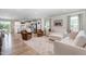 Spacious living room showcasing hardwood floors, comfortable seating, and natural light from a window at 8615 Kenridge Ln, Fuquay Varina, NC 27526