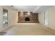 Spacious basement featuring a brick fireplace and neutral carpet at 1000 Winona Rd, Raleigh, NC 27609