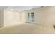 Open basement area with walkout doors and neutral carpet at 1000 Winona Rd, Raleigh, NC 27609