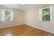 Bright bedroom with hardwood floors and two large windows at 1000 Winona Rd, Raleigh, NC 27609