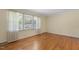 Spacious bedroom featuring wood flooring, large window allowing natural light to fill the room at 1000 Winona Rd, Raleigh, NC 27609