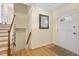 Welcoming entryway with hardwood floors, a stylish mirror, and a staircase leading to the upper level at 1000 Winona Rd, Raleigh, NC 27609