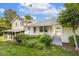 Charming yellow home featuring a well-maintained lawn and lush garden at 1000 Winona Rd, Raleigh, NC 27609