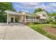 Inviting home showcasing a brick facade, a covered carport, and a meticulously landscaped front yard at 1000 Winona Rd, Raleigh, NC 27609