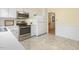 Modern kitchen featuring stainless steel appliances, white cabinetry, and durable flooring at 1000 Winona Rd, Raleigh, NC 27609