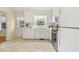 Cozy kitchen space featuring stainless steel appliances, white cabinets, and a view to the exterior at 1000 Winona Rd, Raleigh, NC 27609