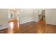 Bright living room featuring hardwood floors and view of staircase at 1000 Winona Rd, Raleigh, NC 27609