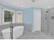 Modern bathroom with a freestanding tub and glass-enclosed shower at 1003 Wicksteed Ct, Apex, NC 27502