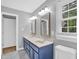 Bathroom featuring dual sinks, framed mirrors, with natural light from window at 1003 Wicksteed Ct, Apex, NC 27502