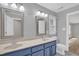 Bathroom features dual sinks, framed mirrors, and a royal blue vanity at 1003 Wicksteed Ct, Apex, NC 27502
