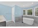 Bathroom boasts a luxurious soaking tub beneath bright windows at 1003 Wicksteed Ct, Apex, NC 27502