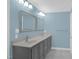 Bathroom featuring dual sinks, framed mirrors, and contemporary light fixtures at 1003 Wicksteed Ct, Apex, NC 27502