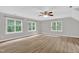Spacious bedroom features wood-look floors, a ceiling fan, and large windows providing natural light at 1003 Wicksteed Ct, Apex, NC 27502