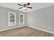 Bright bedroom featuring new floors and view from light-filled windows at 1003 Wicksteed Ct, Apex, NC 27502