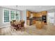 Open dining area featuring hardwood floors, kitchen access, and natural light at 1003 Wicksteed Ct, Apex, NC 27502
