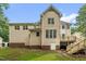Two-story home with walkout basement, wooden deck, and mature landscaping at 1003 Wicksteed Ct, Apex, NC 27502