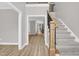 Bright foyer featuring new floors, a staircase with wood and iron accents, and an open floor plan at 1003 Wicksteed Ct, Apex, NC 27502