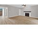 Bright living room featuring wood-look floors, a fireplace, and an open layout at 1003 Wicksteed Ct, Apex, NC 27502