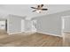 Spacious living room featuring wood-look floors, neutral walls, staircase, and seamless access to the kitchen at 1003 Wicksteed Ct, Apex, NC 27502