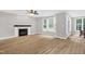 Inviting living area with wood-look floors, fireplace, and bay window providing plenty of natural light at 1003 Wicksteed Ct, Apex, NC 27502