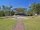 Community amphitheater with a modern design, a fountain, paved walkway, and grassy seating area at 101 Temple Gate Dr, Cary, NC 27518