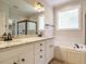 Bright bathroom with granite counters, double sinks, separate shower, and soaking tub at 101 Temple Gate Dr, Cary, NC 27518